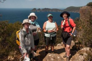 Hiking in Tasmania 2019 event with Tasmanian Iconic Walks happy participants enjoying the view