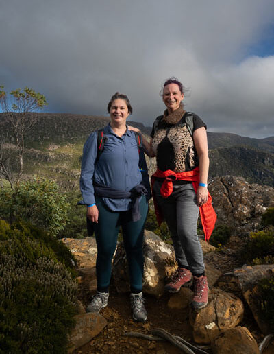 2024 tarn shelf fundraising hikers standing on rocks with tasmanian iconic walks